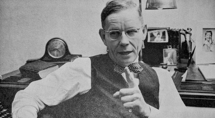 A notable alumnus, ‘Mr. Baptist’ served Mercer throughout his life | Mercer Legends black and white photo of a man sitting at a desk and holding a pipe