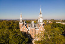 5 Mercer students selected for inaugural Presidential Fellowship A drone photo of a five-story brick building with tall spires, with trees surrounding it.