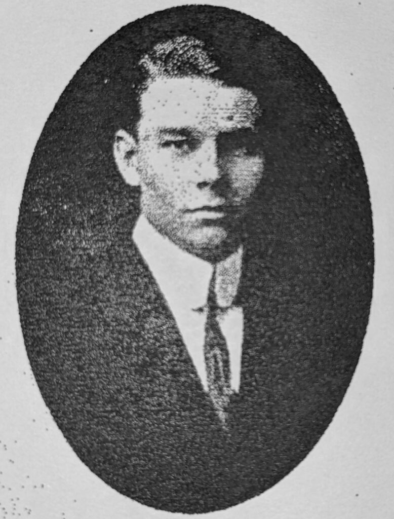 black and white headshot of a young man in a suit