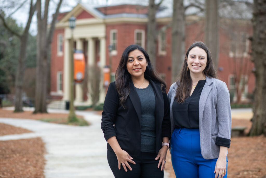 two women stand in Mercer's historic quad