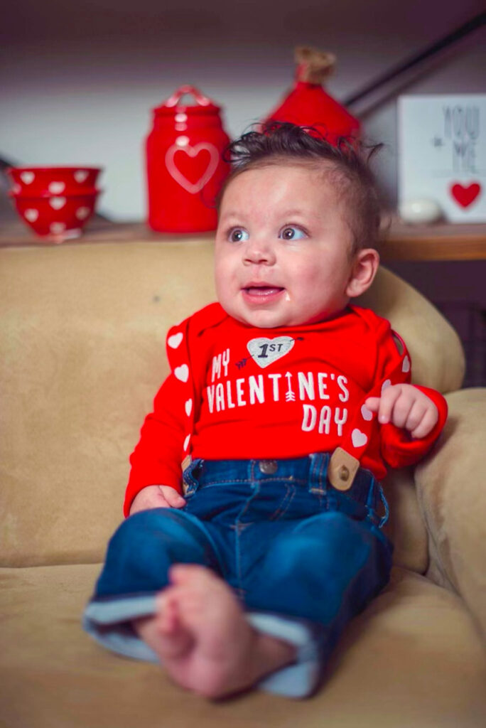 a baby wearing a shirt that says my 1st valentine's day