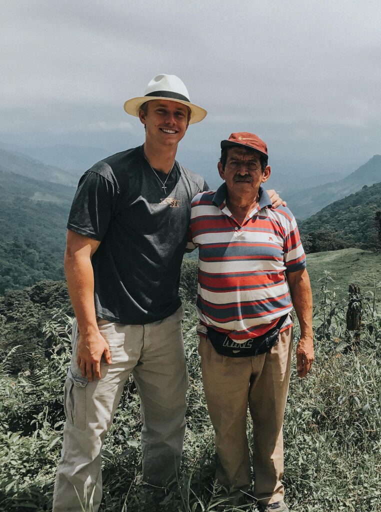 two men stand on the hills in ecuador