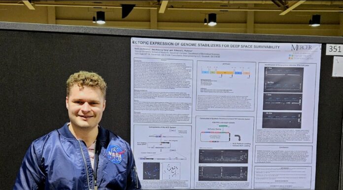 School of Medicine student wins prize for his ‘biological spacesuit’ at NASA workshop A Mercer student wearing a blue jacket with a NASA patch holds iPad that displays a space suit. He is standing next to a poster titled: Ectopic Expression of Genome Stabilizers for Deep Space Survivability.
