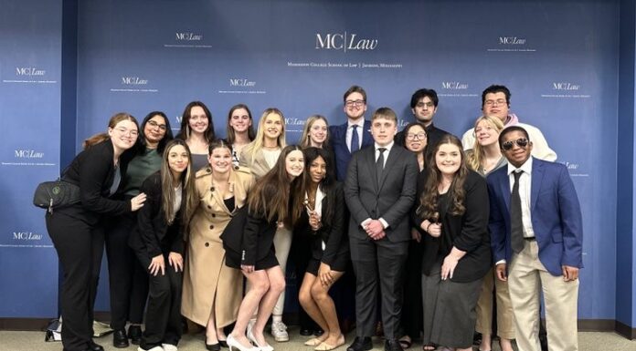Mock Trial Team takes home top individual awards at regionals groups of college students posing, smiling with gavels