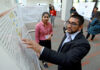 16th annual Atlanta Research Conference to showcase student, faculty scholarship man pointing at a whiteboard. Woman looking on.