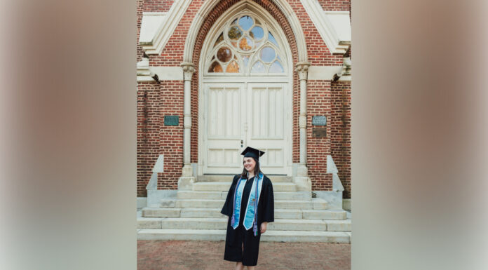 Graduate Spotlight: Molly McRae woman in graduate cap and gown standing in front of building