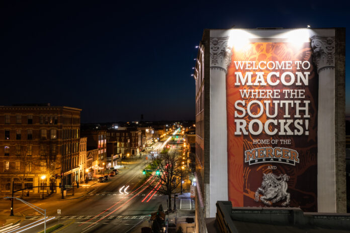 Downtown Macon streetscape showing a banner down the side of a building that says "Welcome to Macon Where the South Rocks!"