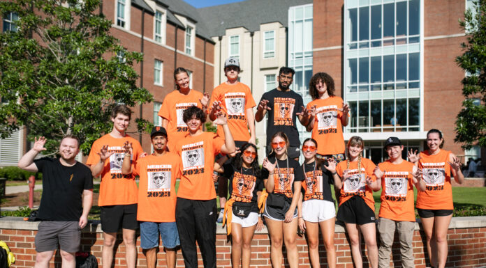 4 things to know about Mercer’s 2024 Opening Days and Bear Beginnings Fourteen students pose for a photo in front of Legacy residence hall. They are smiling, wearing orange and black and shaping their hands into a bear claw. The shirts feature the head of a bear wearing sunglasses and the words "Mercer University 2023 Opening Day."