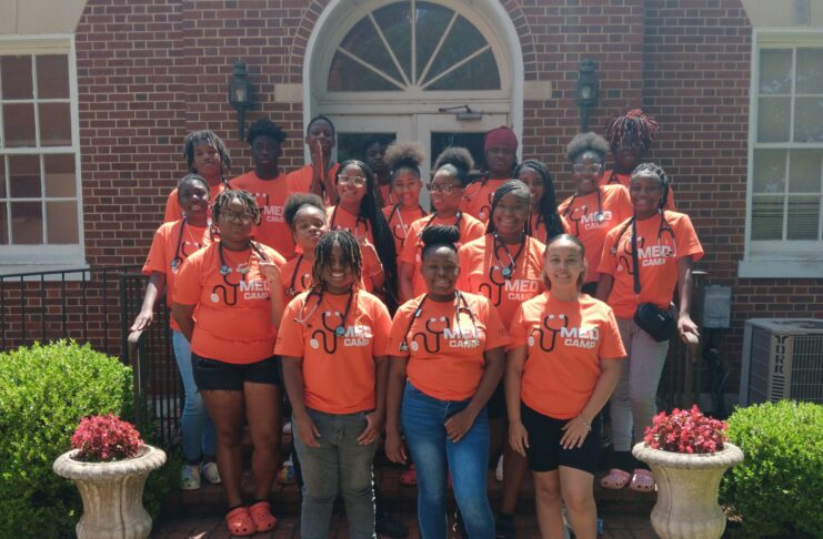 Group of students in orange T-shirts with 