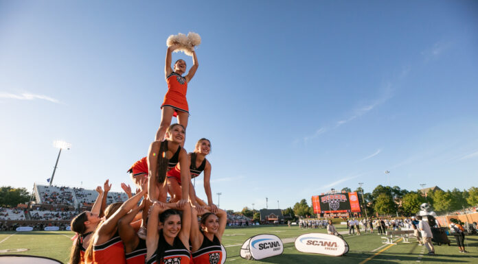 3 things to know about Mercer’s home opener vs. Presbyterian: Aug. 29, 2024 Cheerleaders wearing Mercer uniforms form a pyramid on the sidelines of a football field. A game in going on in background and people are in the stands.