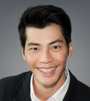 Headshot of Benjamin Tan wearing a white dress shirt and black suit jacket.