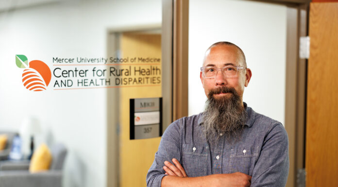 School of Medicine names director of Center for Rural Health and Health Disparities Michael Kramer standing confidently in front of the Mercer University School of Medicine, Center for Rural Health and Health Disparities.