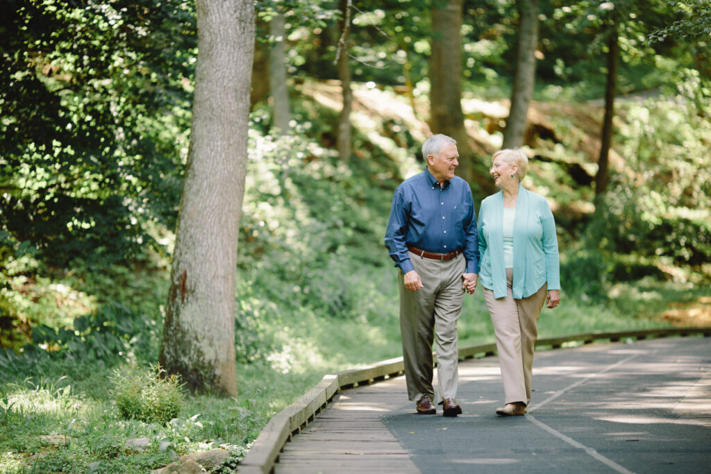 Nathan Deal and Sandra Deal walk down a wooded street.