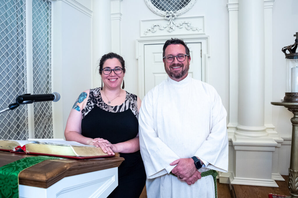 Melissa Lester and Rev. Scott Hovey standing behind the church pulpit.