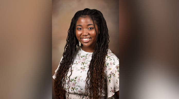Senior says ACP Summer Internship prepared her for the world of health care A woman smiling and wearing a floral-patterned top with long braided hair. The background is a soft, neutral, and slightly blurred color gradient