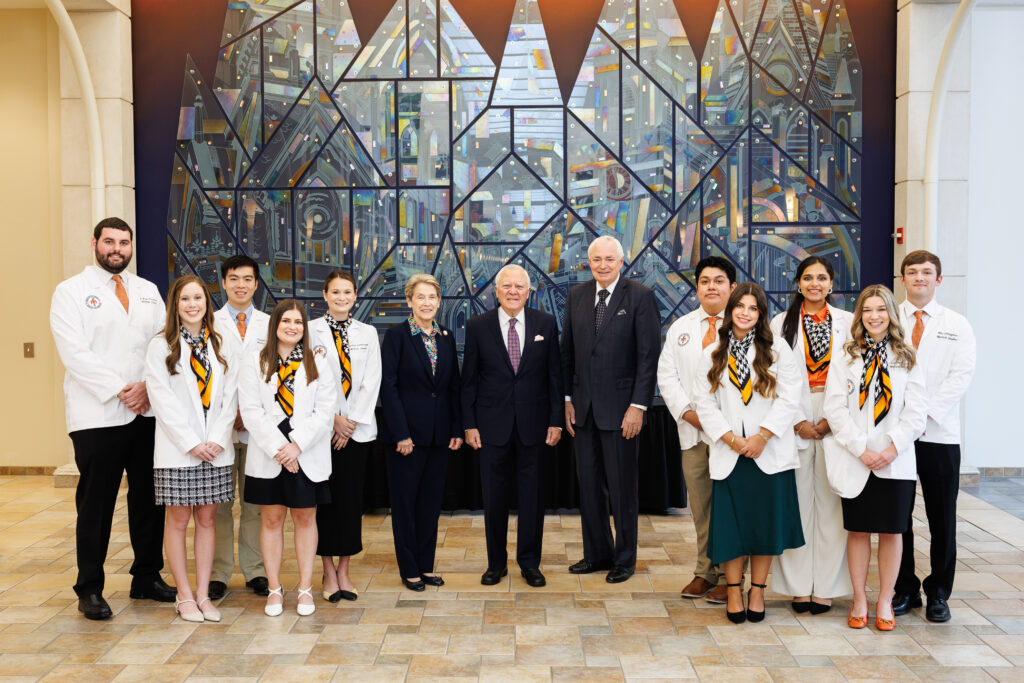 2024 Nathan Deal scholars with Dr. Sumner, Governor Deal, President Underwood in front of glass mural