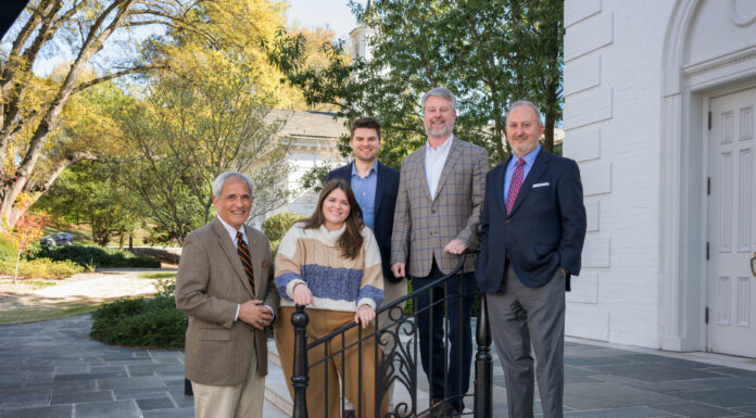 Mercerians lead Atlanta church’s ministry team Five individuals posing together on the steps outside a church. They are professionally dressed, smiling, and standing near a black metal railing.