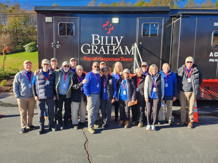 Group of people standing together in front of a Billy Graham Rapid Response Team truck.