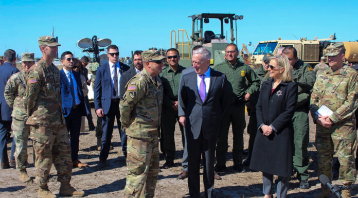 Mercer ROTC instructor left chiropractic career to join the Army Craig Mattoon talks to James Mattis and Kirstjen Nielsen outdoors, with a group of people standing around them.