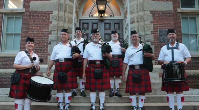 Hearing bagpipes on campus? Chances are it’s the Mercer Pipes and Drums band Group of seven people in traditional Scottish attire, including kilts, standing on steps with bagpipes and drums.