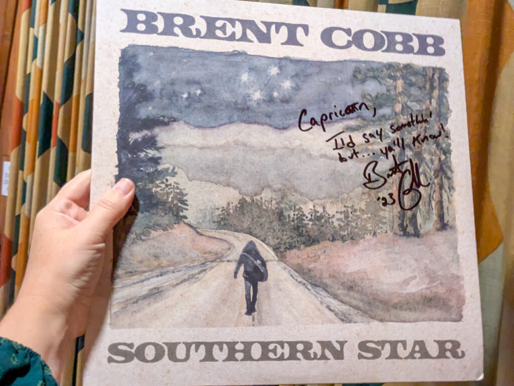 A signed copy of Brent Cobb's "Southern Star" album, featuring a person walking on a dirt road.