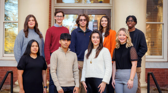 Office of Global Engagement awards 22 scholarships for students to study abroad A group of nine people standing on steps in front of a building, posing for a photo.