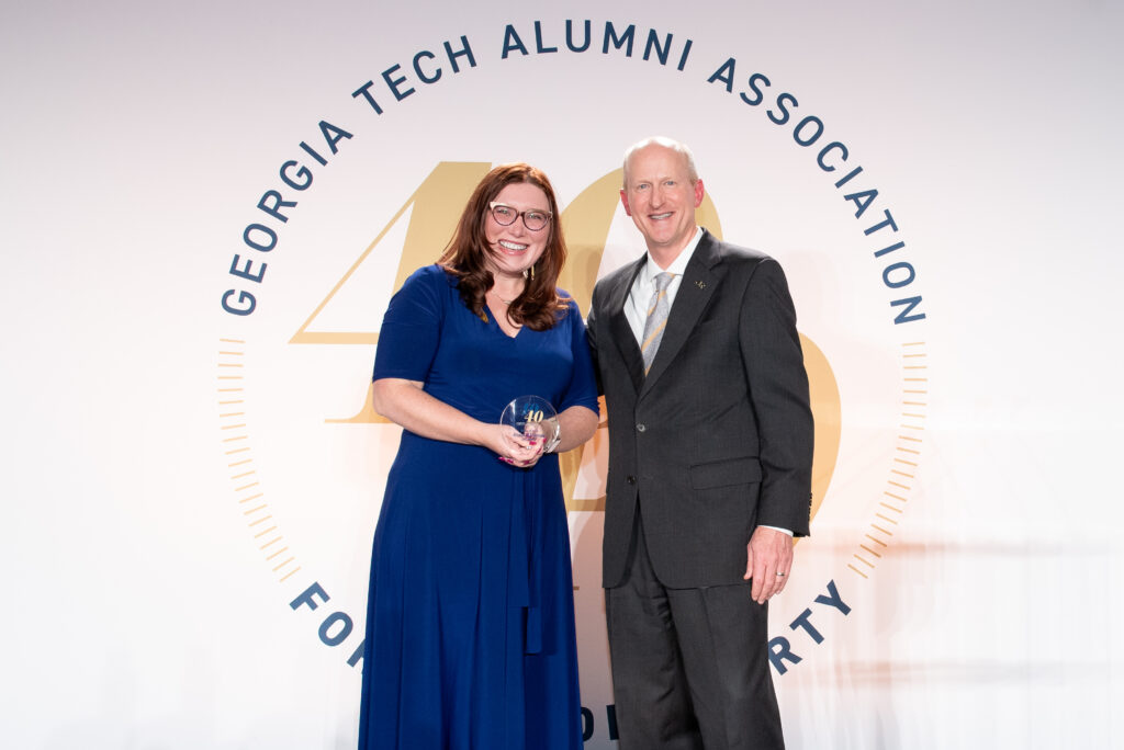 Two people standing and smiling in formal attire at a Georgia Tech Alumni Association event.