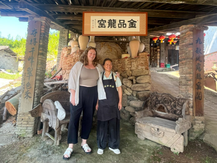 Mary O'Malley and another woman stand in a dragon kiln.