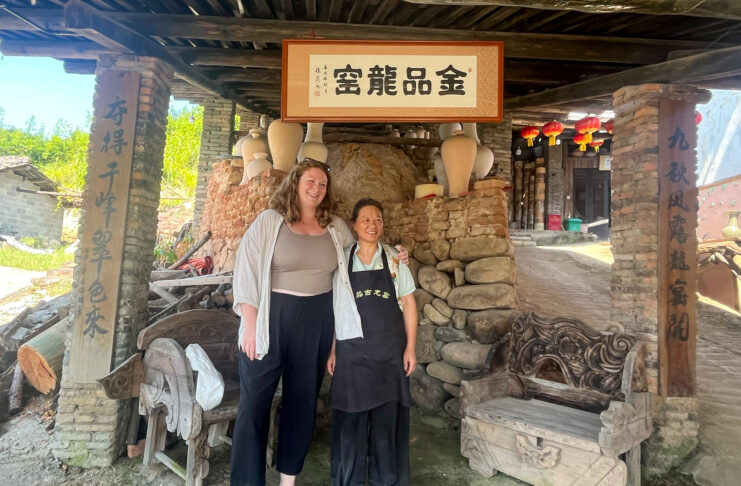 Mary O'Malley and another woman stand in a dragon kiln.