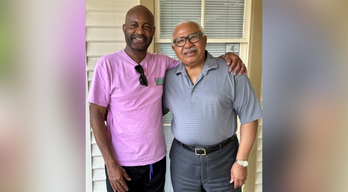 Mentorship experience serves as inspiration to Mercerian decades later Two men standing together, smiling, with one wearing a pink shirt and the other in a gray polo.
