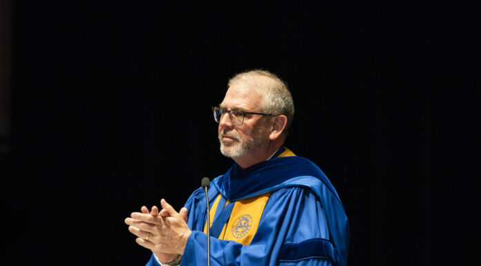 In times of suffering, try to be a good steward of your pain | Dr. Craig McMahan Dr. Scott Davis speaks at a podium against a dark background.