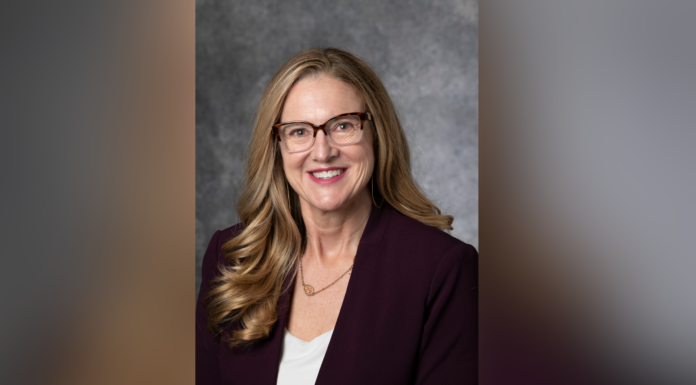 Scholar, author Jaime Clark-Soles to deliver Mercer’s annual Harry Vaughan Smith Lecture Woman with long hair in a purple blazer and glasses, smiling against a gray background.