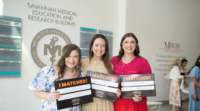 School of Medicine celebrates National Residency Match Day 2025 Three people holding I Matched! signs in a medical university building.