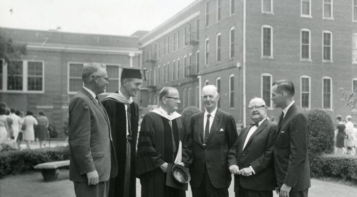 Carl Vinson ‘dedicated his life to America’s strength, security, freedom’ | Mercer Legends Six men, some in academic robes, stand conversing on a lawn in front of a brick building.