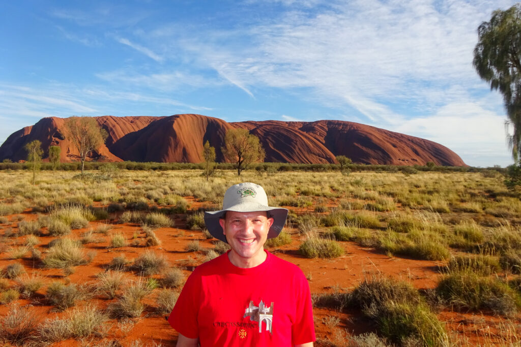 Brad Lindsey stands in front of a desert landscape in Australia.