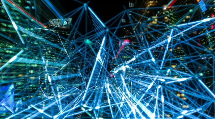 Generative AI and large language models take center stage at Informatics Day 2025 Abstract image of a cityscape at night with overlaid blue lines and bright lights, resembling a digital network.
