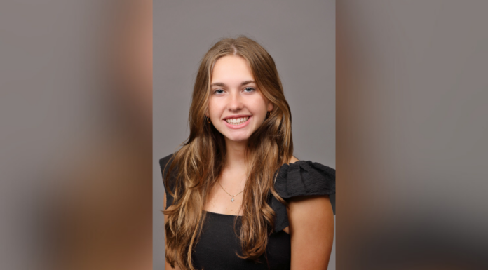 Sophomore selected for prestigious Amgen Scholars Program Smiling person with long hair wearing a black top against a neutral background.