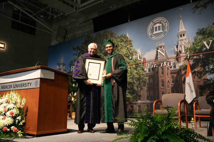 2505_MedSchoolCommencement_CiSmith-610 Mercer President William D. Underwood presents Myles Nicholas Duncan with a framed award.