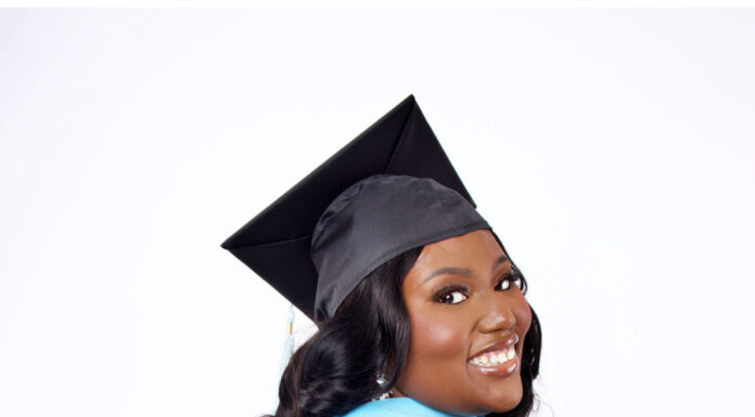 Graduate Spotlight: Artisha Wright Artisha Wright, in a graduation cap and gown, smiles while posing against a plain white background.