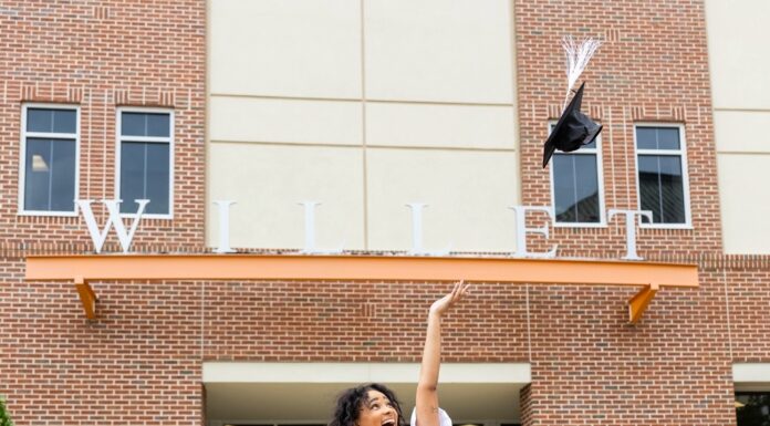 Graduate Spotlight: Ashley Boone Ashley Boone, in a white dress and orange sash, throws her cap in the air outside the Willet Science Center.