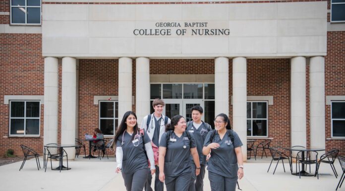 College of Nursing receives $500,000 grant to increase graduates entering the Georgia workforce Five nursing students in scrubs walk together outside the Georgia Baptist College of Nursing building.