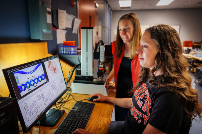 ainsley-westbrook-2 Ainsley Westbrook and Dr. Joanna Thomas are in a lab reviewing scientific data displayed on a computer monitor.