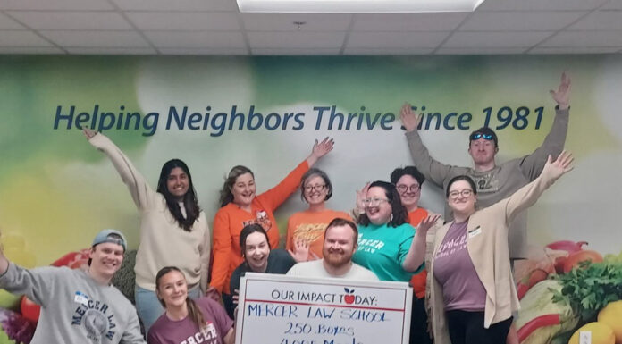 Mercer Law wins 14th annual Georgia Legal Food Frenzy A group of people poses indoors, holding a sign that reads, Mercer Law School: 250 Boxes, 4,005 Meals.