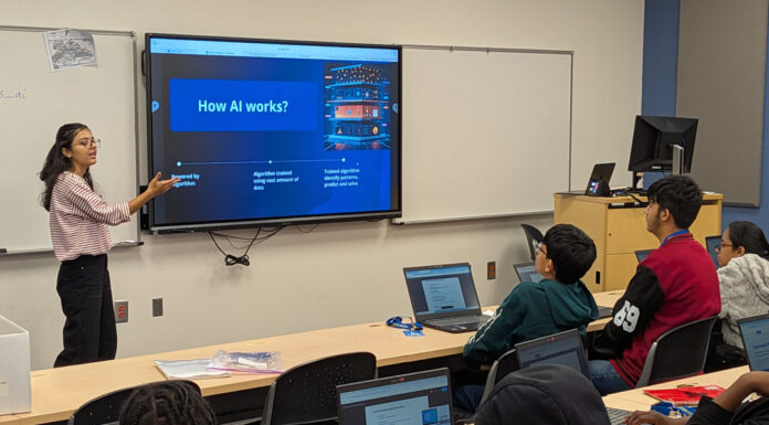 Mercer student creates AI curriculum for youth as part of summer research project Kusum Neupane presents a slide titled How AI works? to students seated at desks with open laptops in a classroom.