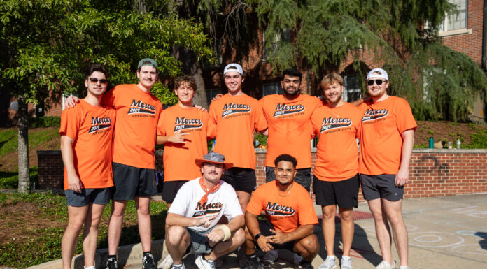 4 things to know about Mercer’s 2025 Opening Days and Bear Beginnings Eight people in matching orange Mercer shirts and one in white pose together outside on a sunny day.