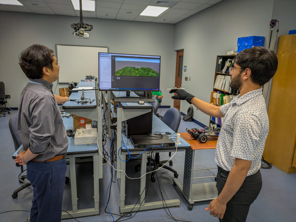 Dr. Hunmin Kim observe and interact with a computer simulation displayed on a monitor, using hand gestures.