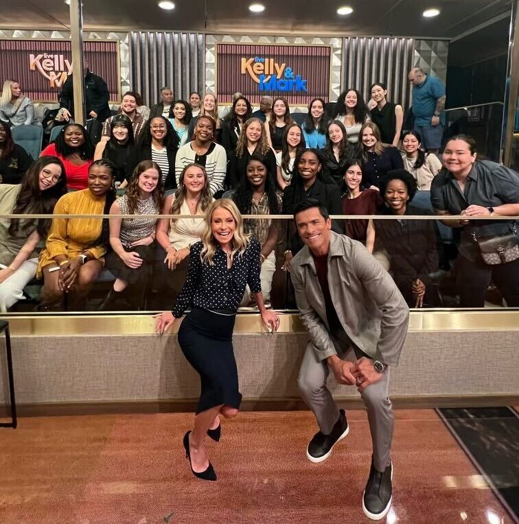 Two hosts pose in front of a studio audience on the set of Live with Kelly and Mark.