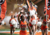 3 things to know about Mercer vs. Presbyterian football game day: Aug. 30, 2025 Mercer cheerleaders wave and carry flags on a football field.