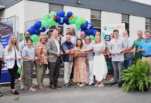 Kids Alliance for Better Care celebrates Evans Memorial Hospital’s emergency department as part of the Pediatric Emergency Care Project A group of people stand in front of a building holding a ribbon for a ribbon-cutting ceremony with balloons overhead.