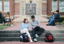 Get back to the work that feeds your soul | Dr. Greg DeLoach Two Mercer students sit on steps outside a building, studying together with backpacks nearby; others sit on benches in the background.